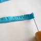 Roll the fringed paper into a tight coil with a quilling tool