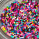 Prepared oven-safe bowl with Perler beads layered up the sides.