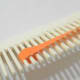 Wrap quilling paper around three prongs of the comb.
