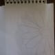 Positioning the outline onto the sketchbook, ready for tracing and transferring the image.