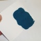 Pour the loose powder off onto a spare sheet of paper.