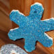 Glittered ornaments made by painting dried pieces with glue and sprinkling with glitter.