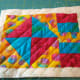 This mug rug is quilted using diagonal lines marked on the quilt.