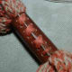 Tuck the short end inside the leather, and use the long end to stitch x's along your leather cinch. I used 4 stitches for every crosspiece, to make sure it would stay secure.