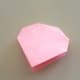 Close the paper and press down on the corners which are at the top of the folded paper.