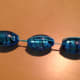 Thread the bead through twice so that the bead can move but also stay were it is.