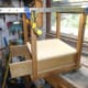 Using sash clamps to hold the legs in position when fixing the drawer support shelf and base.