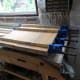 Clamping the planks together until the glued dowelled joints set.