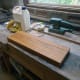 Four identical pieces of wood cut from oak, sanded and waxed with beeswax.