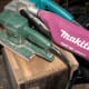 Cleaning the carcass of the tool box with a belt sander