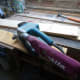 Using a belt sander to smooth rough wood.