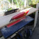 Trimming wood to the correct width with a bench saw.