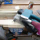 Belt sander to smooth down rough-cut roofing battens.