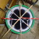 Canes secured in place across the bottom of a bucket for tying the wicks to.