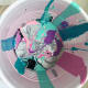 Paint can be poured into the large cup in any way. You can add all of one color at once, or a small amount at a time until the smaller cups are empty.