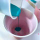Pouring the smaller cups into the larger one