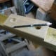 Using the base plate as a template to mark out the holes in the post.