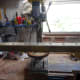 Using the bench drill to drill the holes in the post.