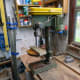 Positioning the base plate on the bench drill for drilling the two holes.