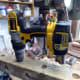 Using electric drill to pilot hole through the post holes, to indicate where to use the bench drill on the other side to complete the holes.