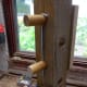 Steel tent peg used as retaining pin. Holes drilled in wooden pegs for tent peg to drop into place.