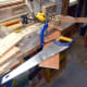 Shortening the two ends of the middle shelf, to account for the dado joint in the two end supports.