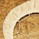 Repeat the same process of threading and pulling the twine with each of the loops you created.