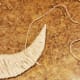 Flip your moon over so the back is facing you. Knot your twine about 2 1/2 inches from the top point.