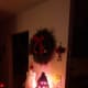 A wreath with with soft lighting brings out the spirit of Christmas.