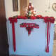 A inviting entryway with pretty reds and a small tree lighten up the space.