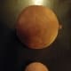 Dryer ball before and after washing, showing how much they shrink as they felt together.