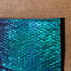 Purchased activewear fabric. The fish scales change from teal to pink with the light.