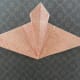 Open the triangle and refold creases to form a mountain as shown.