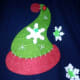 The elf hat is a felt Christmas tree ornament hot glued to an old cotton sweater vest.