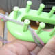Lay double strand of yarn between first two bottom pegs.