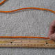 Measure the length of rope needed to fit snuggly around the wrist