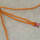 Pull the rope ends to shorten the distance between the two buckles