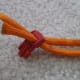 Thread the two ends of rope through the other buckle