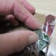 Firmly press the piece with the thin layer of adhesive into the design location