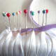 Pin the purple ribbon down before wrapping the pins