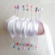 Wrap the white ribbon around the top and bottom pins