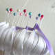 Start wrapping the ribbon around the pins