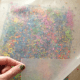 crayons are sandwiched between two sheets of waxpaper