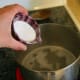 Add 3 tbsp. washing soda to 2 cups water. Bring the solution to a boil, then remove from heat.