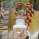 A bottle decorated with pressed roses