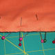 Pin the 2nd piece of fabric to the bottom piece, making sure to include the pom pom lace.