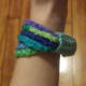 Multi-coloured chain stitch bangle with band.