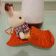Third step: Sit down and start inserting your legs into the blanket. Wiggle your body until your legs reach the end.