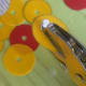 Punch a hole in the middle of each disc.