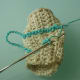 Crocheting through the dc post, sideways, and working 2 sc in each dc post. Here is my hook inserted through the next dc post.